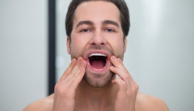 Healthy teeth. Man with open mouth examining his teeth