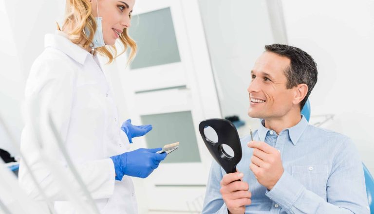male-patient-choosing-tooth-implant-in-modern-dent-2021-08-29-19-39-16-utc-scaled